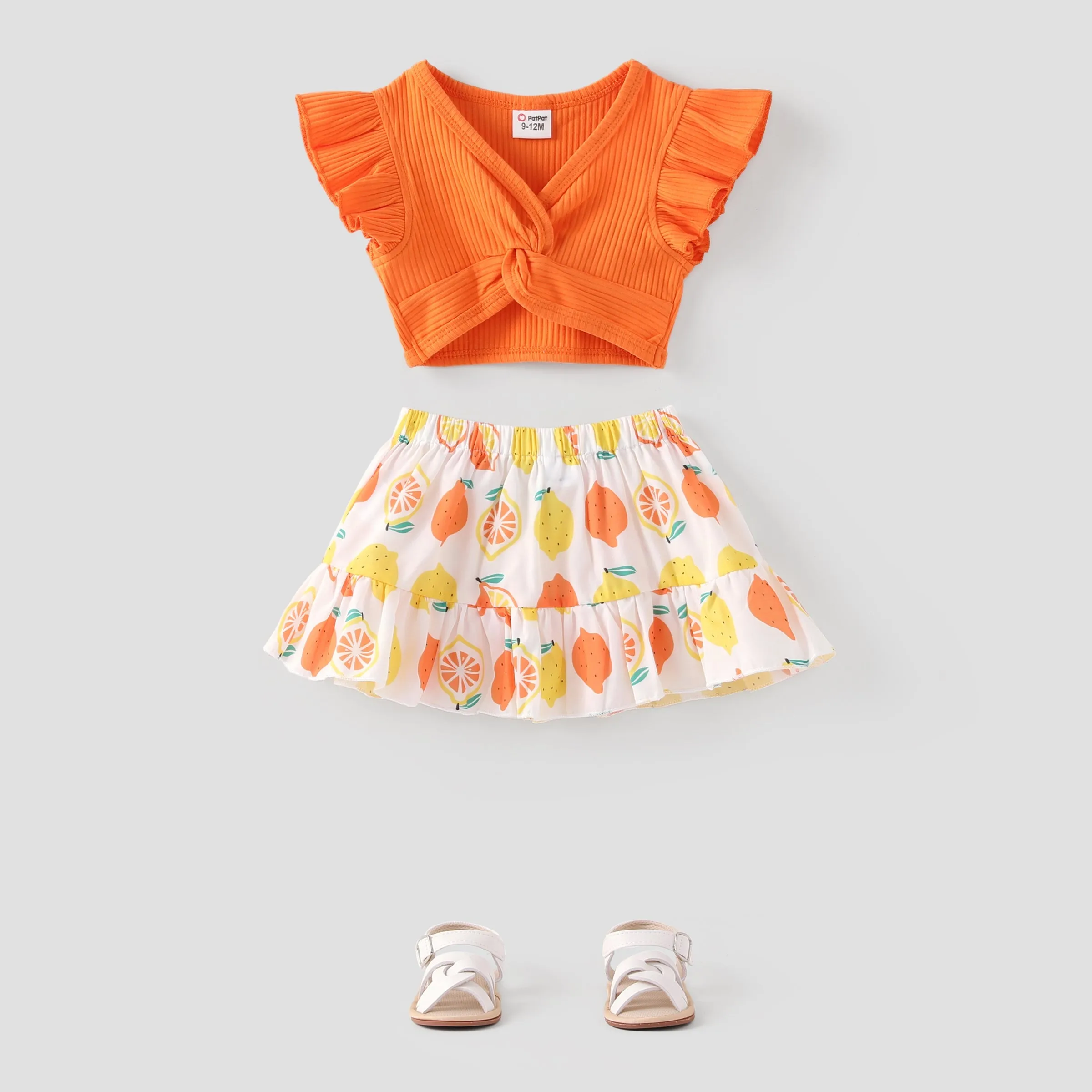 2pcs Baby Girl Solid Cotton Ribbed Ruffle-sleeve Twist Knot Crop Top and Allover Fruit Print Skirt Set