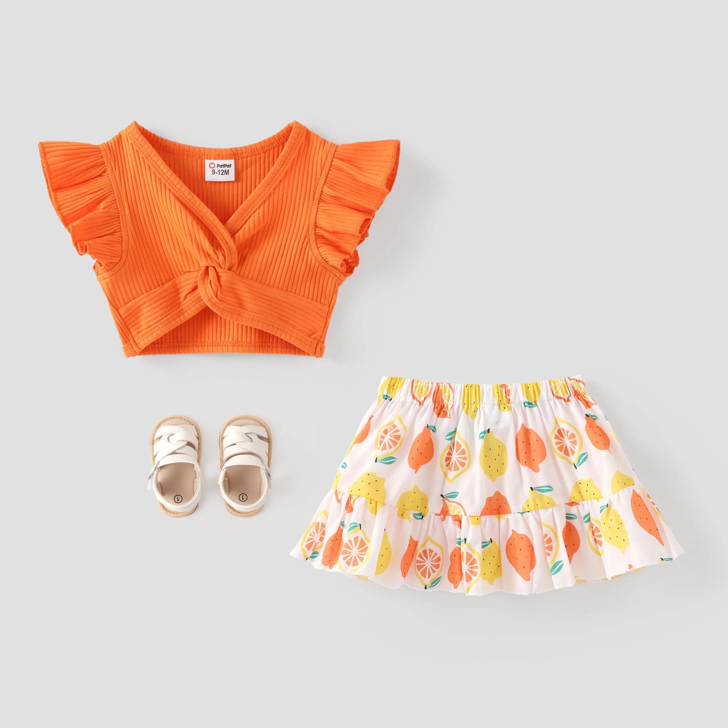 2pcs Baby Girl Solid Cotton Ribbed Ruffle-sleeve Twist Knot Crop Top and Allover Fruit Print Skirt Set